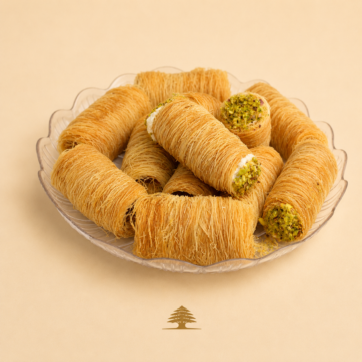 Crispy kataifi rolls filled with ashta cream and dipped in crushed pistachios